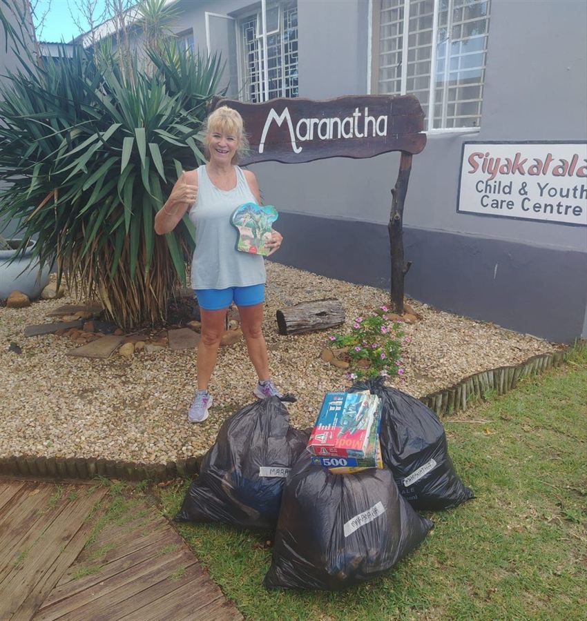 Robyn with bags of donated goods outside a local child and youth care centre