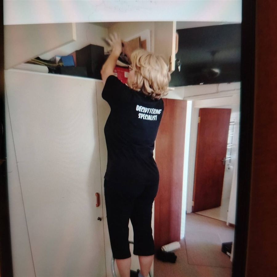 A built-in cupboard Robyn has reorganised, every shelf given a job