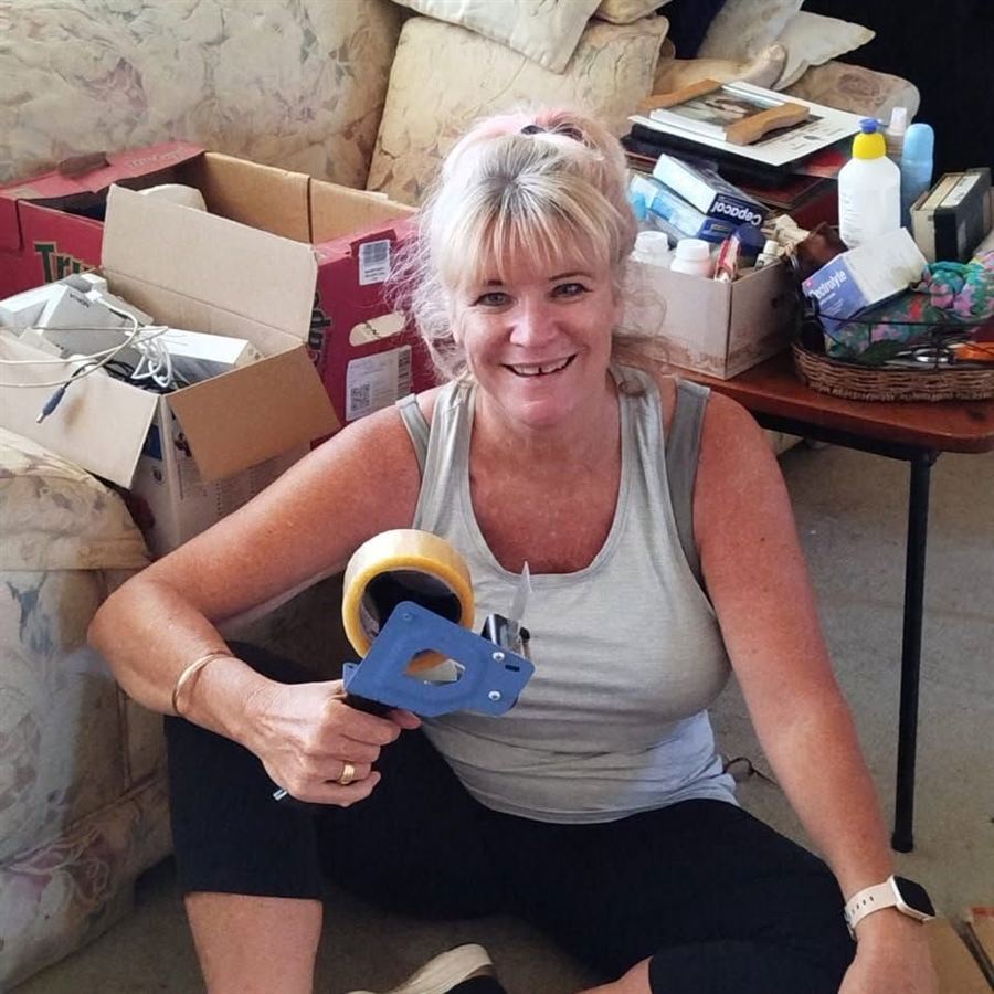 Robyn taping up boxes ready for a move