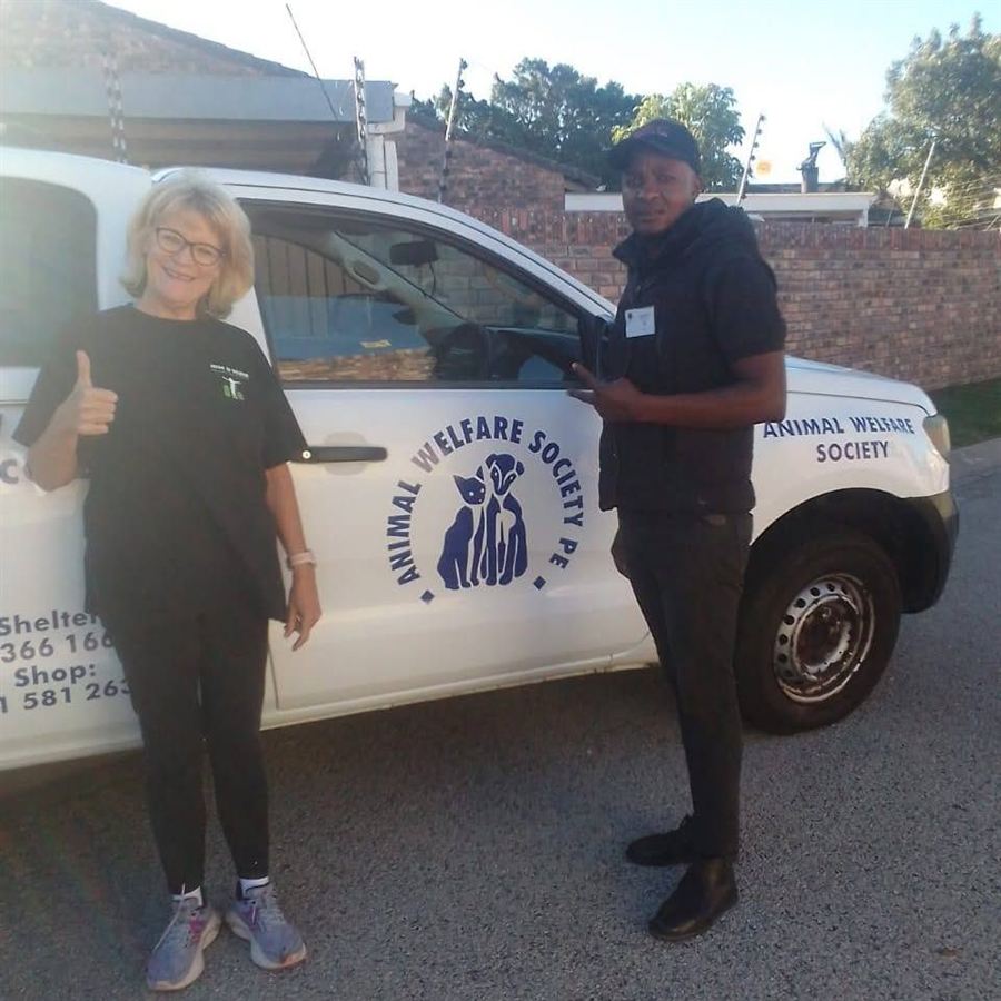 Robyn with an animal welfare charity's collection vehicle and one of their staff