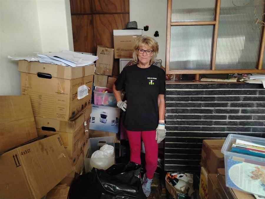 Robyn with a home packed into labelled boxes, ready for the move